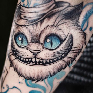 grinsekatze tattoo bedeutung